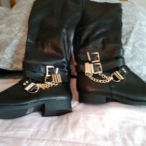 High-top black boots with gold chain
